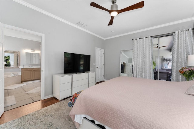 13108 Lakeshore Grove Dr, Winter Garden, FL 34787 - bedroom with wood finished floors, crown molding, connected bathroom, ceiling fan, and baseboards