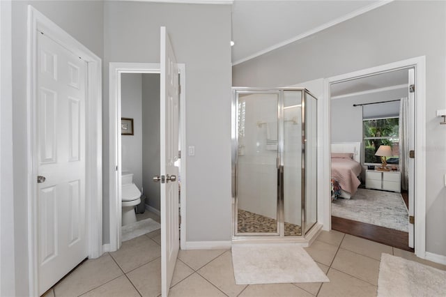 13108 Lakeshore Grove Dr, Winter Garden, FL 34787 - bathroom with crown molding, a stall shower, toilet, tile patterned flooring, and baseboards