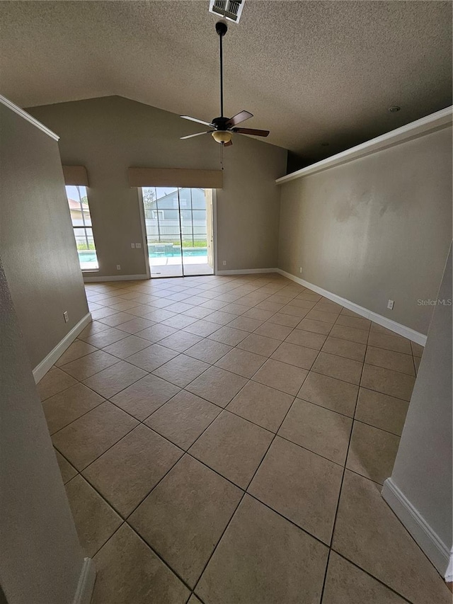 1710 Canoe Creek Rd, Oviedo, FL 32766 - unfurnished room with vaulted ceiling, tile patterned floors, ceiling fan, a textured ceiling, and baseboards