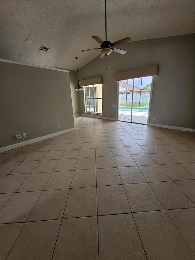 1710 Canoe Creek Rd, Oviedo, FL 32766 - empty room with a textured ceiling, ceiling fan, lofted ceiling, baseboards, and light tile patterned flooring