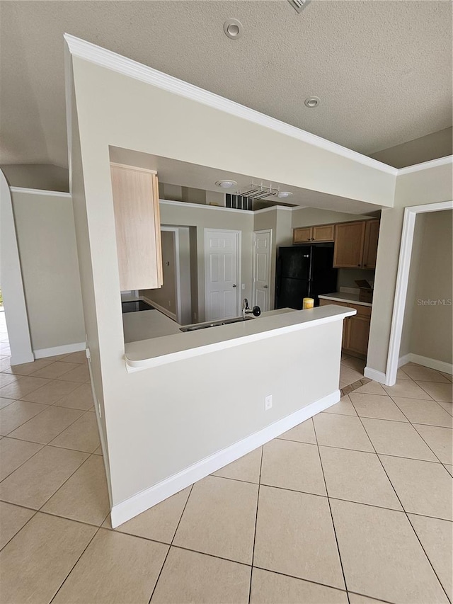 1710 Canoe Creek Rd, Oviedo, FL 32766 - kitchen featuring freestanding refrigerator, ornamental molding, light tile patterned floors, baseboards, and light countertops
