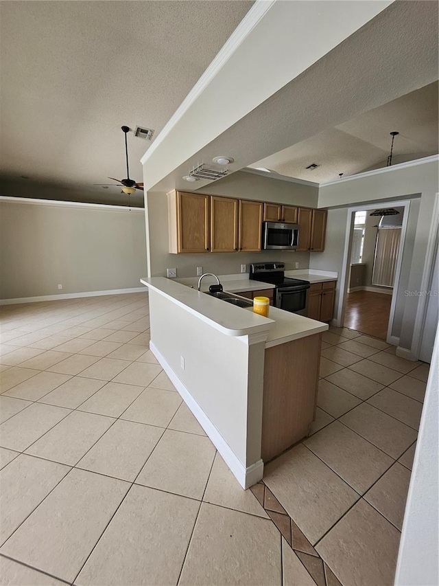 1710 Canoe Creek Rd, Oviedo, FL 32766 - kitchen featuring appliances with stainless steel finishes, crown molding, light tile patterned floors, a textured ceiling, and light countertops