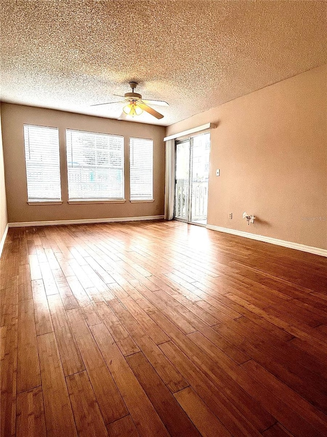 1057 S Hiawassee Rd Unit 1913, Orlando, FL 32835 - spare room featuring baseboards, hardwood / wood-style floors, ceiling fan, and a textured ceiling