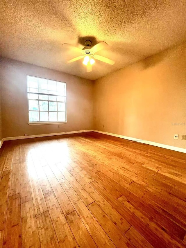 1057 S Hiawassee Rd Unit 1913, Orlando, FL 32835 - empty room featuring wood-type flooring, ceiling fan, a textured ceiling, and baseboards