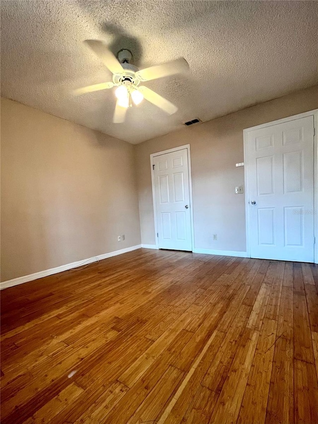 1057 S Hiawassee Rd Unit 1913, Orlando, FL 32835 - unfurnished bedroom featuring wood-type flooring, baseboards, a textured ceiling, and ceiling fan