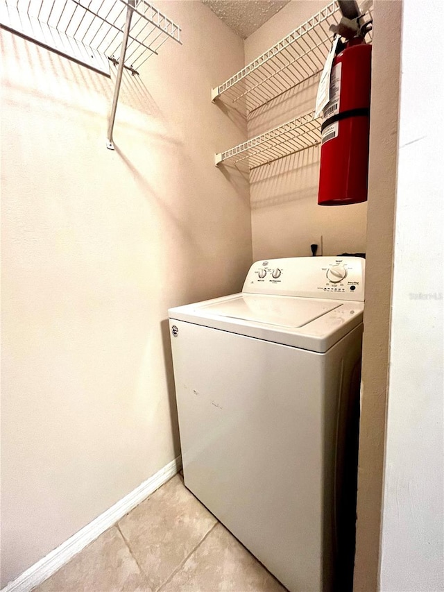 1057 S Hiawassee Rd Unit 1913, Orlando, FL 32835 - washroom featuring washer / dryer, baseboards, and light tile patterned floors
