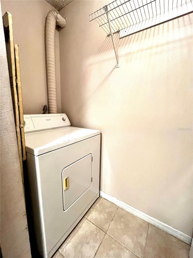 1057 S Hiawassee Rd Unit 1913, Orlando, FL 32835 - washroom with washer / clothes dryer, light tile patterned floors, and baseboards