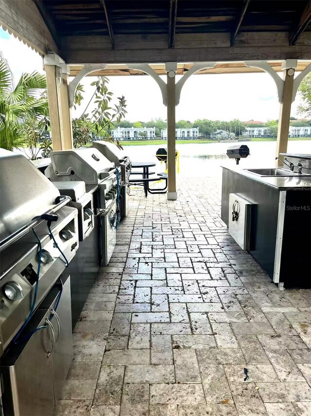 1057 S Hiawassee Rd Unit 1913, Orlando, FL 32835 - view of patio featuring a gazebo, a sink, and a water view