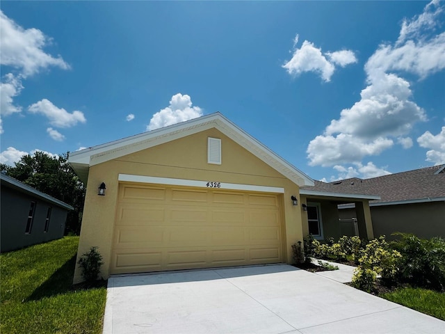 4326 Sagefield Dr, Harmony, FL 34773 - view of front of house featuring stucco siding, concrete driveway, and a garage