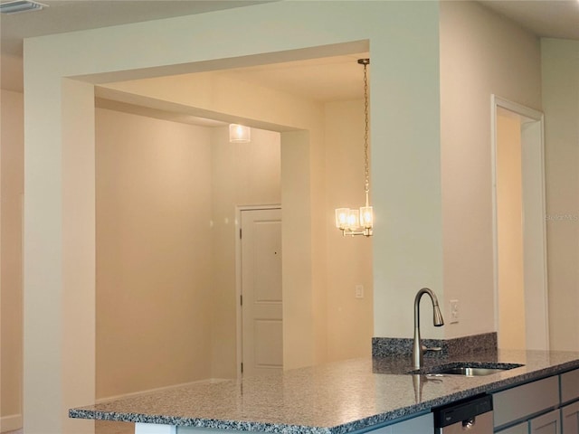 4326 Sagefield Dr, Harmony, FL 34773 - kitchen with a sink, stone countertops, dishwashing machine, a peninsula, and a chandelier