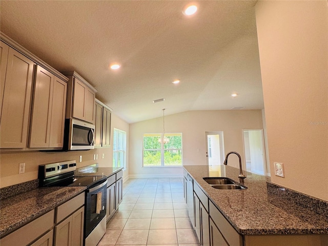 4326 Sagefield Dr, Harmony, FL 34773 - kitchen featuring appliances with stainless steel finishes, a sink, recessed lighting, lofted ceiling, and dark stone countertops