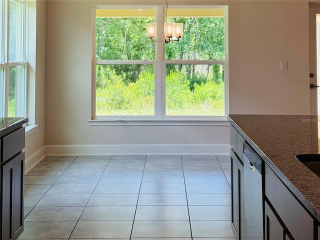 4326 Sagefield Dr, Harmony, FL 34773 - unfurnished dining area with a chandelier, baseboards, healthy amount of natural light, and light tile patterned flooring