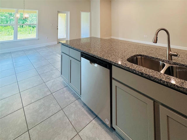 4326 Sagefield Dr, Harmony, FL 34773 - kitchen featuring dishwashing machine, a sink, light tile patterned floors, and dark stone counters