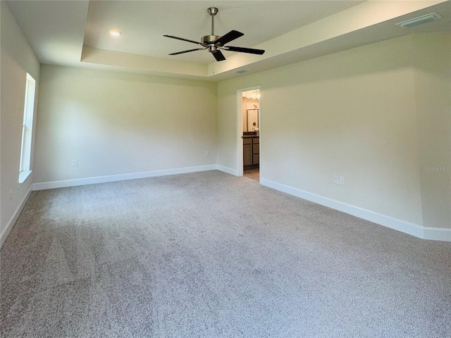 4326 Sagefield Dr, Harmony, FL 34773 - spare room with a raised ceiling, baseboards, light carpet, and ceiling fan