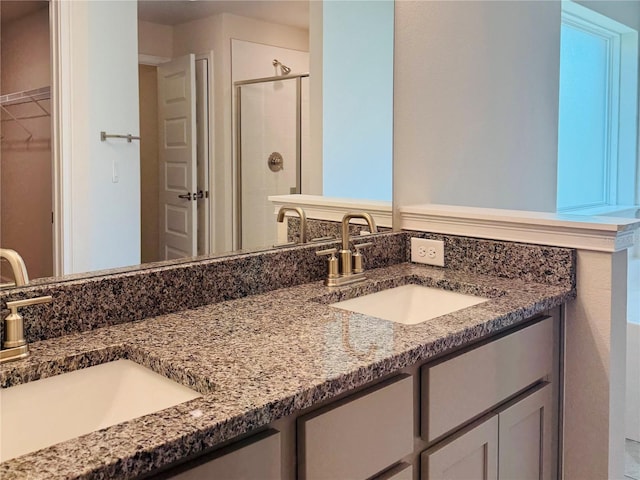 4326 Sagefield Dr, Harmony, FL 34773 - full bathroom featuring double vanity, a shower stall, and a walk in closet