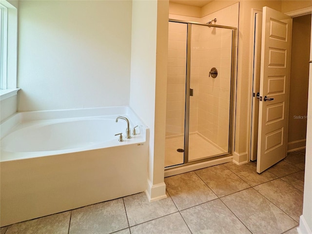 4326 Sagefield Dr, Harmony, FL 34773 - bathroom featuring a bath, a stall shower, and tile patterned flooring