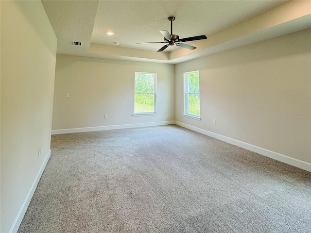 4326 Sagefield Dr, Harmony, FL 34773 - carpeted spare room featuring a tray ceiling, baseboards, and ceiling fan