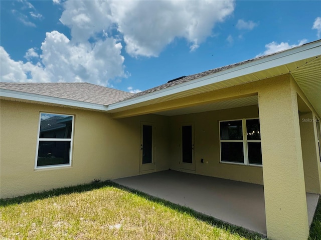 4326 Sagefield Dr, Harmony, FL 34773 - back of property featuring stucco siding, a patio, a yard, and roof with shingles