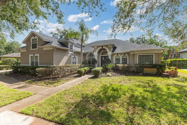 2046 Westover Reserve Blvd, Windermere, FL 34786 - view of front of home with stucco siding and a front yard