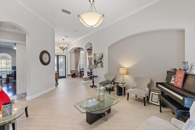 2046 Westover Reserve Blvd, Windermere, FL 34786 - living room featuring arched walkways, crown molding, light wood finished floors, baseboards, and a chandelier