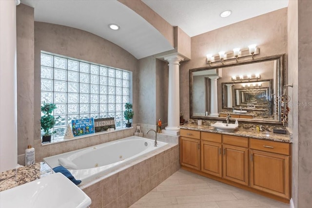 2046 Westover Reserve Blvd, Windermere, FL 34786 - bathroom with ornate columns, a jetted tub, vanity, and lofted ceiling