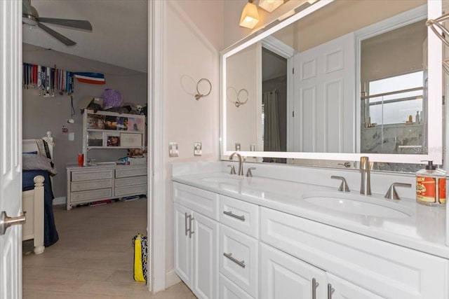 2046 Westover Reserve Blvd, Windermere, FL 34786 - bathroom with double vanity, a shower stall, a spacious closet, ceiling fan, and wood finished floors
