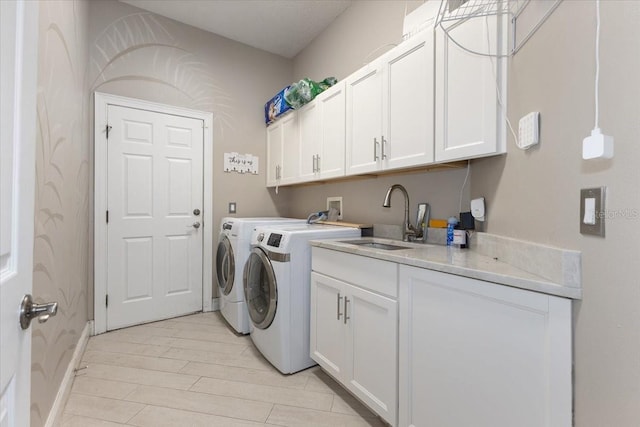 2046 Westover Reserve Blvd, Windermere, FL 34786 - washroom with washer and clothes dryer, cabinet space, baseboards, and light wood-style flooring