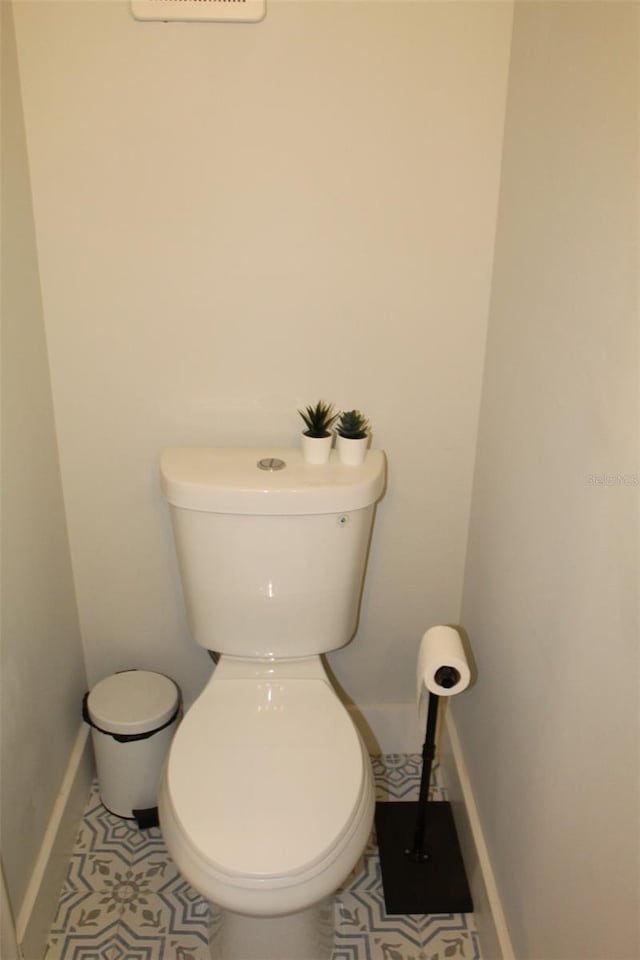 3044 S Oakland Forest Dr Unit 2403, Oakland Park, FL 33309 - bathroom featuring toilet, tile patterned flooring, and baseboards