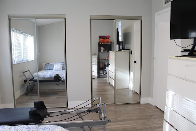 3044 S Oakland Forest Dr Unit 2403, Oakland Park, FL 33309 - bedroom featuring two closets, wood finished floors, and baseboards