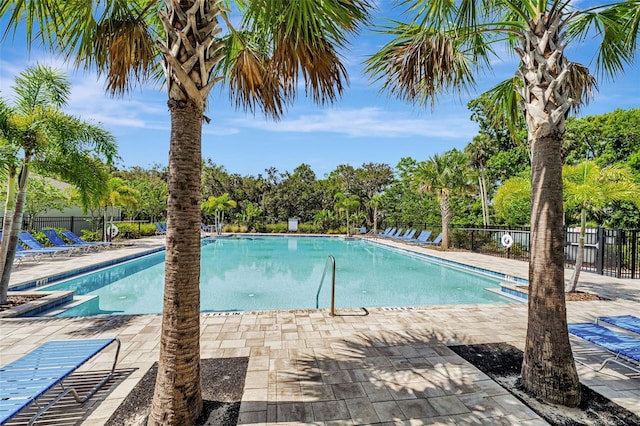 29400 Caspian St, Leesburg, FL 34748 - community pool featuring a patio area and view of wooded area