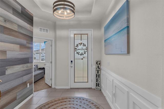 10815 Laxer Cay Loop, San Antonio, FL 33576 - entryway with a raised ceiling, a chandelier, and light tile patterned floors