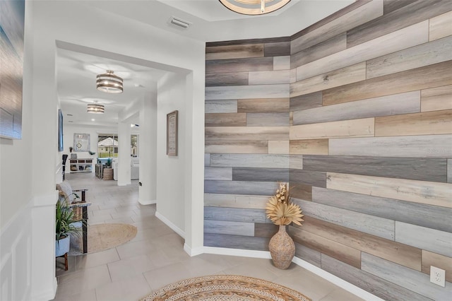 10815 Laxer Cay Loop, San Antonio, FL 33576 - corridor featuring wooden walls and tile patterned floors
