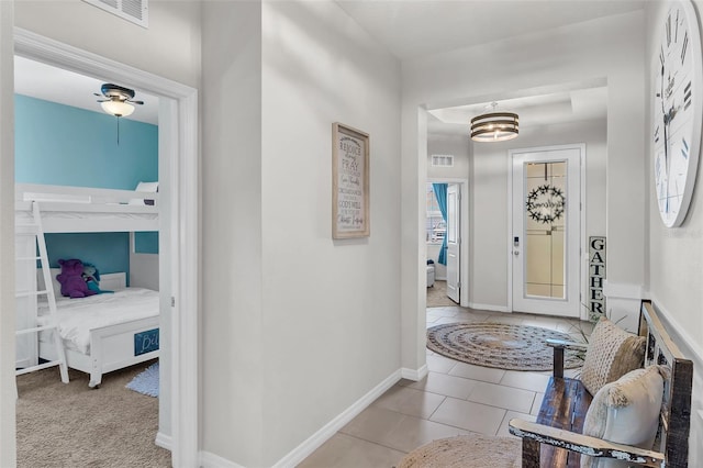10815 Laxer Cay Loop, San Antonio, FL 33576 - tiled foyer featuring baseboards and a chandelier