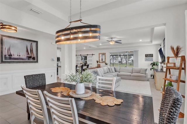 10815 Laxer Cay Loop, San Antonio, FL 33576 - dining space featuring a ceiling fan, tile patterned floors, and a tray ceiling