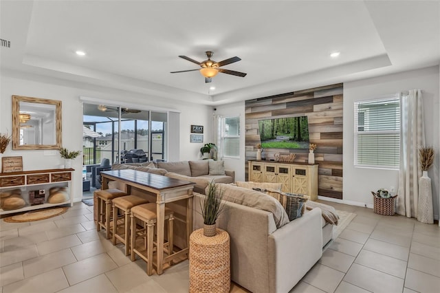 10815 Laxer Cay Loop, San Antonio, FL 33576 - living area with a tray ceiling, a ceiling fan, recessed lighting, and light tile patterned floors