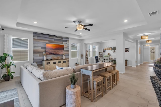 10815 Laxer Cay Loop, San Antonio, FL 33576 - living area featuring a raised ceiling, baseboards, ceiling fan, and recessed lighting
