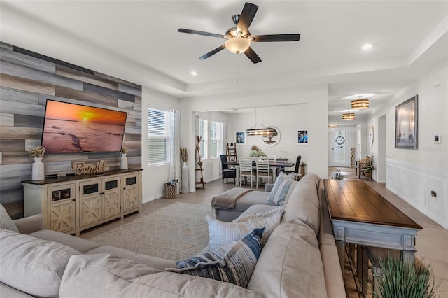 10815 Laxer Cay Loop, San Antonio, FL 33576 - living area featuring a ceiling fan, recessed lighting, an accent wall, and a raised ceiling