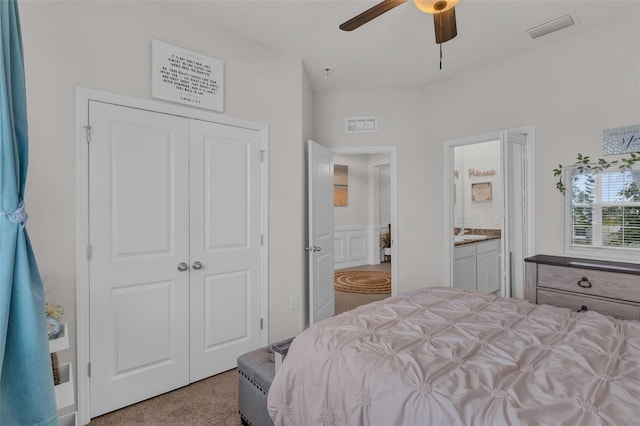 10815 Laxer Cay Loop, San Antonio, FL 33576 - bedroom with carpet, a closet, a ceiling fan, and ensuite bath