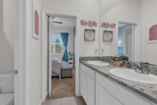 10815 Laxer Cay Loop, San Antonio, FL 33576 - bathroom with connected bathroom, double vanity, toilet, and tile patterned floors