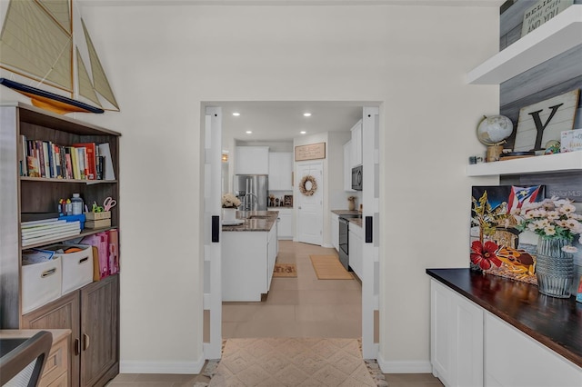 10815 Laxer Cay Loop, San Antonio, FL 33576 - hallway with recessed lighting, baseboards, and light tile patterned floors