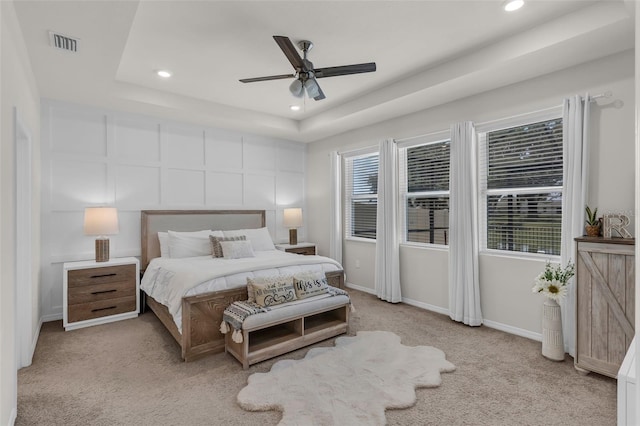 10815 Laxer Cay Loop, San Antonio, FL 33576 - bedroom featuring a raised ceiling, recessed lighting, carpet, and baseboards