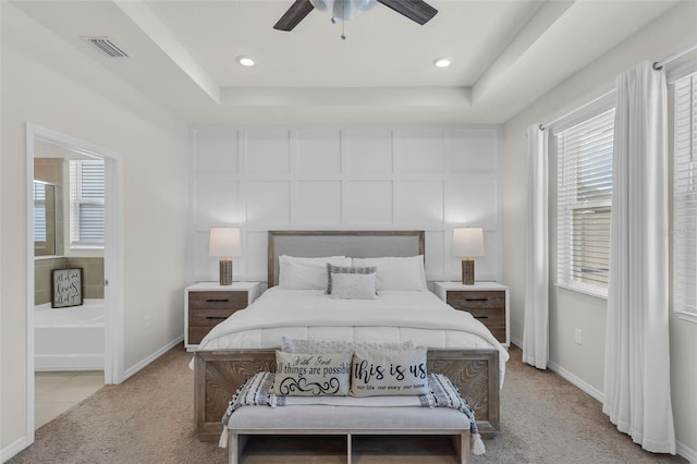 10815 Laxer Cay Loop, San Antonio, FL 33576 - bedroom with light colored carpet, multiple windows, baseboards, a raised ceiling, and recessed lighting