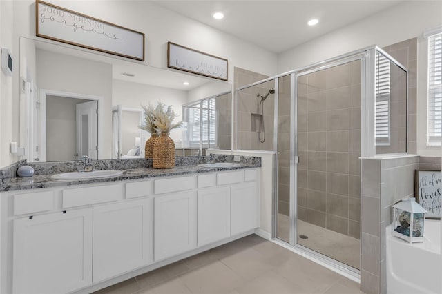 10815 Laxer Cay Loop, San Antonio, FL 33576 - bathroom with a shower stall, double vanity, tile patterned floors, a bath, and recessed lighting