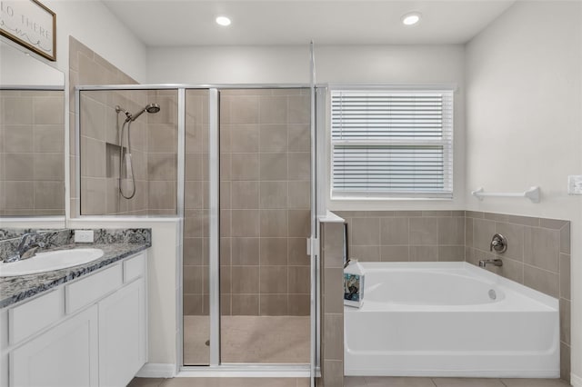 10815 Laxer Cay Loop, San Antonio, FL 33576 - bathroom featuring a garden tub, vanity, a stall shower, and recessed lighting
