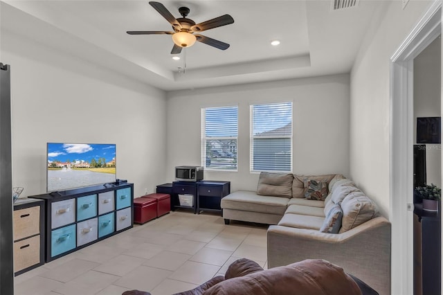 10815 Laxer Cay Loop, San Antonio, FL 33576 - living area with ceiling fan, a tray ceiling, light tile patterned flooring, and recessed lighting