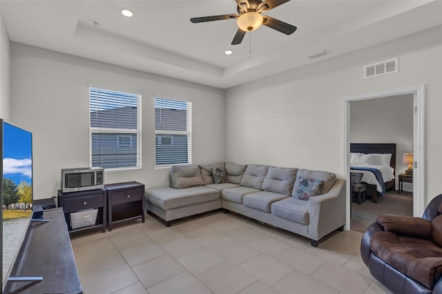 10815 Laxer Cay Loop, San Antonio, FL 33576 - living room featuring a tray ceiling, ceiling fan, light tile patterned floors, and recessed lighting