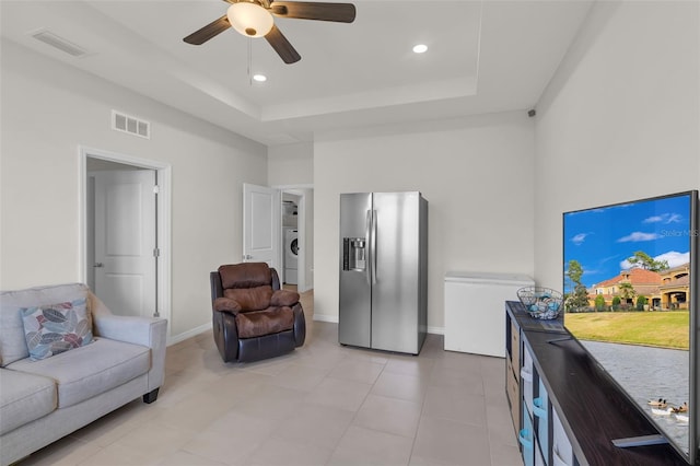10815 Laxer Cay Loop, San Antonio, FL 33576 - living room featuring a raised ceiling, a ceiling fan, washer / clothes dryer, recessed lighting, and light tile patterned floors