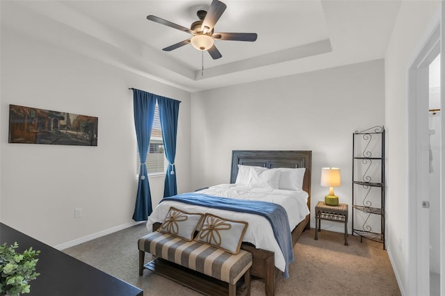 10815 Laxer Cay Loop, San Antonio, FL 33576 - bedroom featuring carpet, a tray ceiling, baseboards, and a ceiling fan