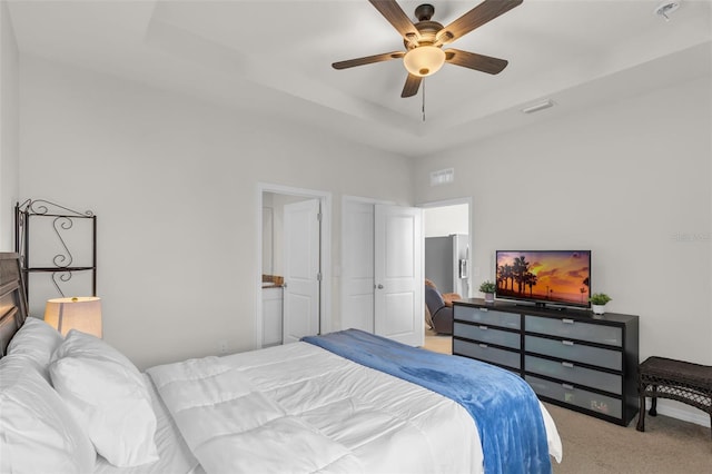 10815 Laxer Cay Loop, San Antonio, FL 33576 - carpeted bedroom with a tray ceiling and a ceiling fan