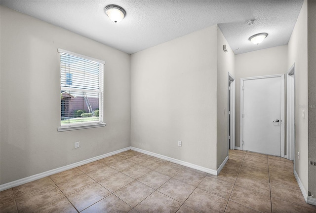 2193 Betsy Ross Ln, Saint Cloud, FL 34769 - spare room featuring tile patterned floors, a textured ceiling, and baseboards